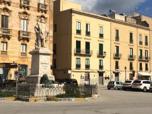a statue of a man in front of a building at Angelica e Orlando in Trapani