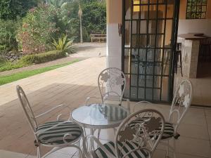 a table and chairs sitting on a patio at Spurwing Guest House in Nairobi