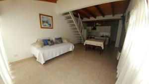 a bedroom with a bed and a staircase with a table at Las Frambuesas in Viedma