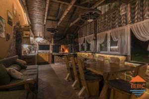 a dining room with a wooden table and chairs at Lake House Bebić in Kupres