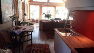 a kitchen and living room with a table and a sink at Art Studio in Sortland