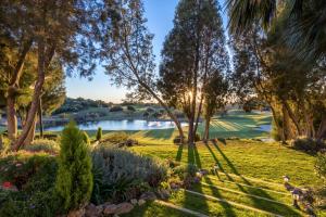 a scenic view of a park with trees and water at Barceló Montecastillo Golf in Jerez de la Frontera
