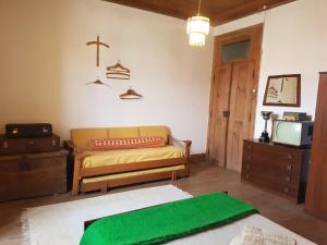 a living room with a couch and a tv at Casa da Vila in Penamacor