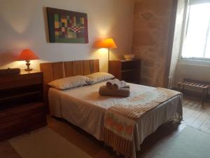 a bedroom with a bed with two towels on it at Casa da Vila in Penamacor +32 photos