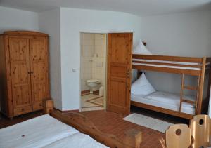 a bedroom with two bunk beds and a toilet at Land Gut Berlinchen in Berlinchen