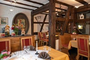 a dining room with a table with wine glasses at Hotel & Restaurant Zum Karpfen in Obernburg am Main