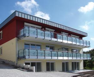 a building with a balcony on top of it at Apartment Ohragrund in Oberhof