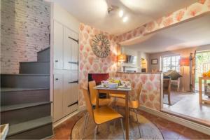a kitchen and dining room with a table and chairs at No33 THORNHAM BOUTIQUE COTTAGE 3 in Thornham +3 photos