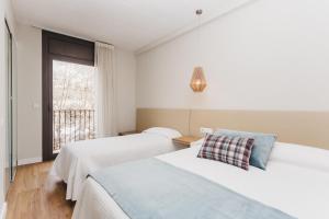 Postel nebo postele na pokoji v ubytování Hotel Catalunya Ribes de Freser + 37 fotografií