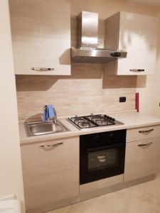 a kitchen with a sink and a stove at Il Grottino in Pescasseroli