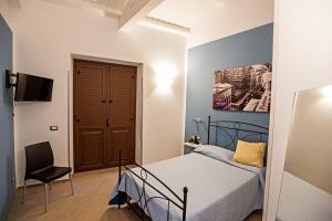 Un pat sau paturi într-o cameră la B&B Acquachiara