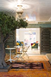 a living room with a table and a tree at Riad SPA "Les Portes de l'Orient" TOURS in Tours