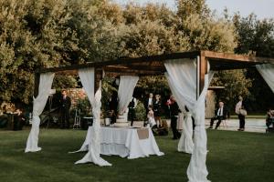 a wedding altar with a white table in the grass at Masseria Baroni Nuovi in Brindisi +272 photos
