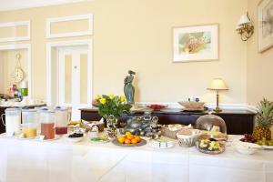 a breakfast table with fruit and other foods on it at The Grange B&B in Shanklin