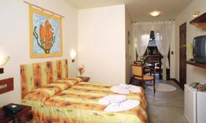 a hotel room with a bed with towels on it at Residencial Vilamar in Ilhabela