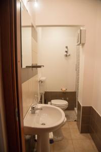 a bathroom with a sink and a toilet at B&B Caffelletto - Papardo in Messina