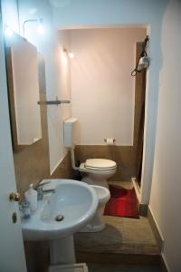 a bathroom with a white toilet and a sink at B&B Caffelletto - Papardo in Messina