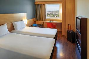 Cama ou camas em um quarto em ibis Sorocaba