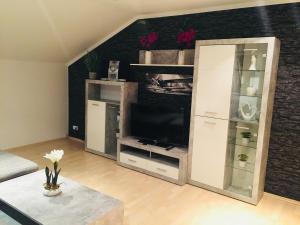 a living room with a large white entertainment center at Ferienwohnung Dhillon in Bernau am Chiemsee