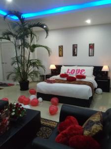 a bedroom with two beds with red pillows at J. I. T HOTEL in Chaltlāng