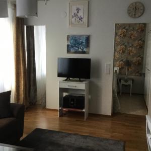 Телевизор и/или развлекательный центр в Finnclub Voyage Luxury Appartment