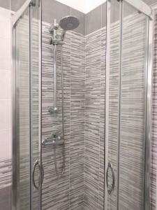 um chuveiro com uma porta de vidro na casa de banho em Camere Mare Manu em Porto Cesareo