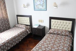 Cama ou camas em um quarto em Ayacucho Palace Hotel