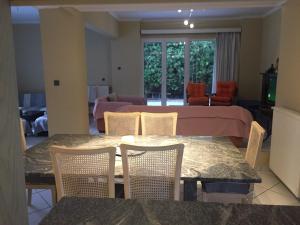 a living room with a table and chairs and a bed at Assos Villa in Káto Ássos