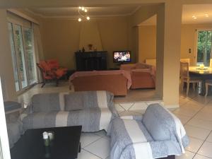 a living room with two couches and a tv at Assos Villa in Káto Ássos