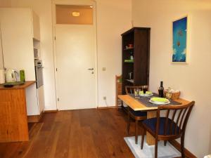 a dining room with a table and chairs and a kitchen at Lovely, central apartment with balcony in Innsbruck