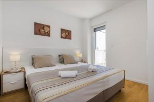 Postel nebo postele na pokoji v ubytování Royal Apartments