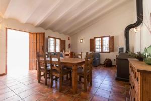a kitchen and dining room with a wooden table and chairs at Finca La Celada in Moratalla