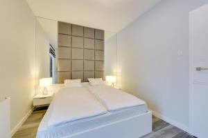 מיטה או מיטות בחדר ב-Rivus - Baltica Apartments