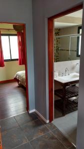 a bathroom with a sink and a mirror at El Breton in Potrero de Garay