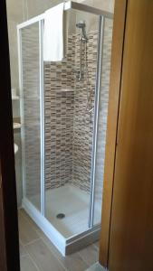 a shower with a glass door in a bathroom at Affittacamere Diavin in Vibo Valentia