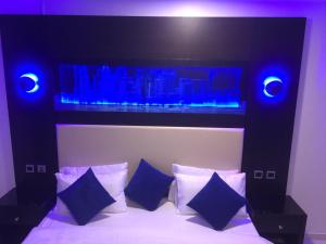 a bedroom with a black and white bed with blue lights at Holiday Furnished Units in Dammam
