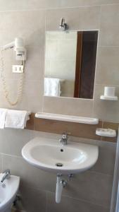 a bathroom with a white sink and a mirror at Affittacamere Diavin in Vibo Valentia