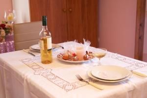 a table with a bottle of wine and a plate of food at Alkmini Studio in Minia