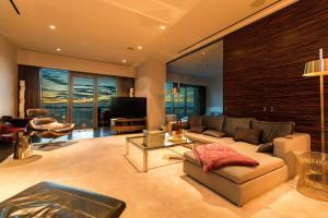 a living room with a couch and a tv at Dream Penthouse at Palms Place in Las Vegas