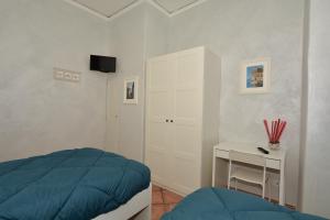 a bedroom with a bed and a desk with a television at Residenza Maranto in Naples