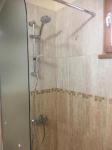 a shower with a glass door in a bathroom at Stylish spacious flat in Sofia