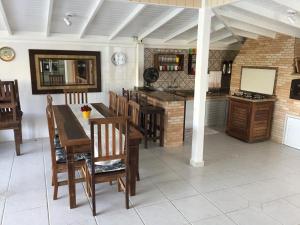 a kitchen with a table and chairs in a room at Casa do Samir in Palhoça