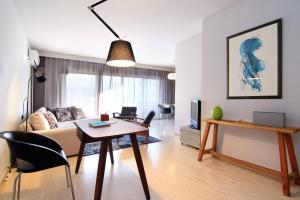 a living room with a couch and a table at Central Apartment in Athens +18 photos