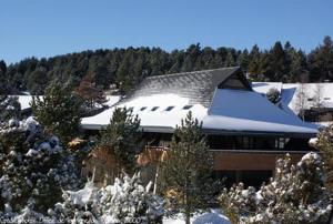 a house with a roof covered in snow at Le Chalet du Ticou in Bolquere Pyrenees 2000