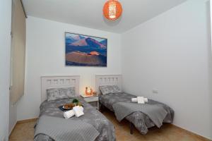 A bed or beds in a room at Apartamento El Pueblo