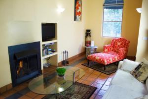 a living room filled with furniture and a fire place at Marwood Luxury Villas in Halls Gap