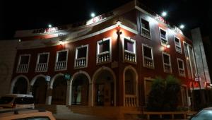 a large red building with lights on it at night at Albergaria Malaposta in Pegões