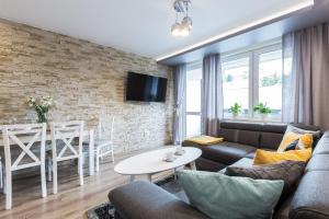 sala de estar con sofá y mesa en Apartamentylove - Apartament Zborowski Centrum, 100m do Krupówek en Zakopane