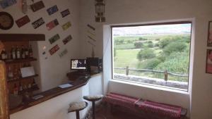 a room with a window with a view of a field at Finca El Carmen Cabañas in Angastaco