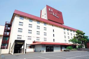 a large white building with a red roof at Yuzawa New Otani in Yuzawa